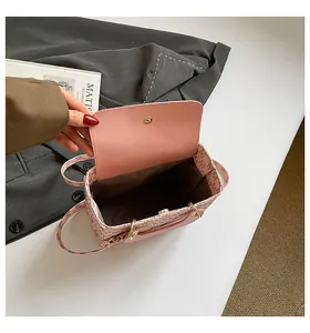 Close-up of pink flap bag showing repeated M monogram pattern and spacious interior