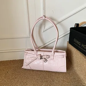 Elegant light pink glossy faux leather shoulder bag with decorative belt and metal buckle