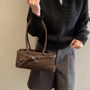 Deep brown minimalist shoulder bag with decorative belt strap and silver ring accent