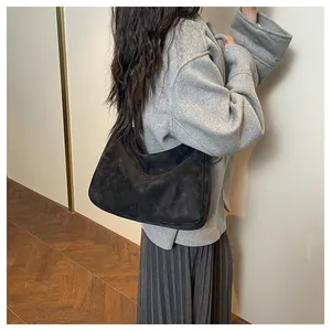 Close-up of black matte suede hobo bag shoulder carry style for minimalist daily look