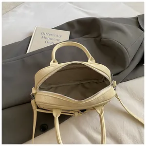 Top-down close-up of the beige leather handbag showing large interior with grey lining