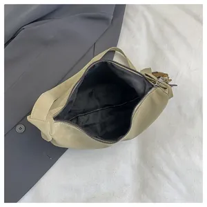 Top view of khaki small square bag showing spacious interior with zipper and black lining