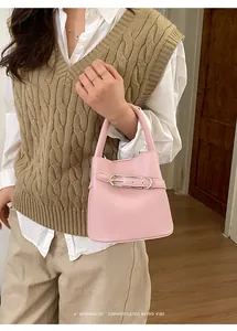Close-up of pink bucket bag with pebble leather texture and elegant silver buckle