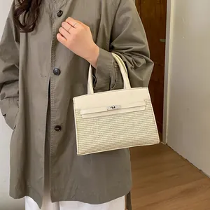 Detailed side view of a cream leather and woven fabric mini square handbag with metal clasp