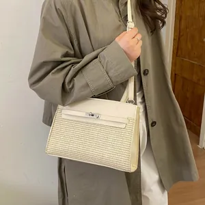 Detail showing the mixed-material texture of a beige leather and woven shoulder bag