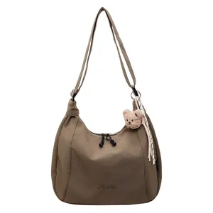 Minimalist coffee brown nylon hobo crossbody bag with cute plush bear and tassel charm