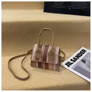 Detail of woven wave pattern and brown leather strap on a stylish mini crossbody bag