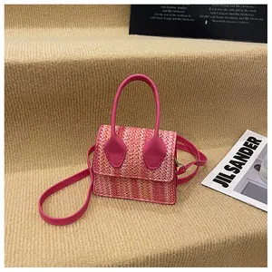 Detail of pink gradient woven small square bag with leather handle and strap