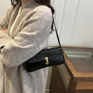 Chic black crocodile embossed underarm bag for women with gold oval twist lock detail