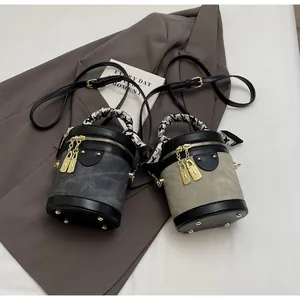 Detailed top view of bucket bags with houndstooth silk scarf handles and gold hardware