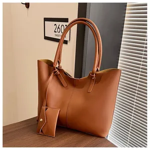 Detail of caramel brown tote bag with matching card holder and gold snap closure