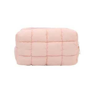 Pink quilted makeup bag with soft padded texture and elegant metal zipper closure
