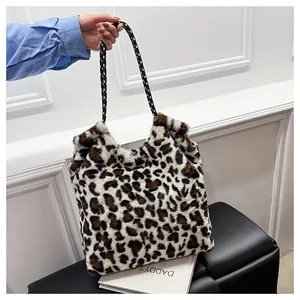 Detail of leopard print faux fur bucket bag with black and white woven rope handle