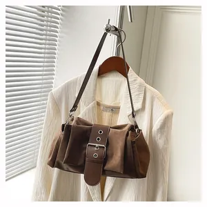 Détail du sac à bandoulière marron vintage avec boucle argentée et texture plissée