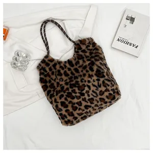 Close-up of leopard print faux fur texture and woven rope handles on the bucket bag
