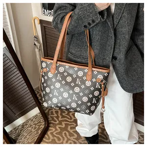 Retro tote bag with monogram canvas and brown leather straps worn with grey blazer