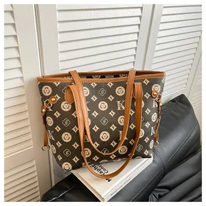 Detailed view of vintage brown tote bag with geometric pattern and leather straps