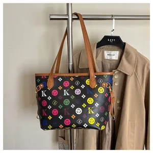 Close-up of printed tote bag with colorful letters and stylish gold metal hardware