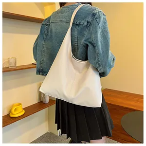 Detailed side view of white large capacity tote bag with soft vegan leather texture