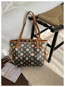 Detail of large vintage tote bag with monogram pattern and adjustable side drawstrings