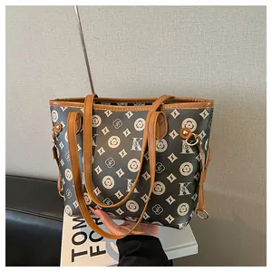 Detail of retro tote bag with brown leather trim and monogram pattern for women