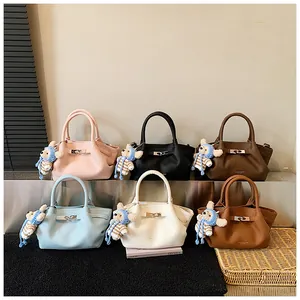 Collection of French bucket bags in six colors with leather texture and bear charms