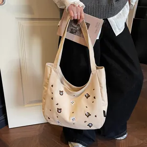 Cream canvas tote bag with bear and cat embroidery and wide shoulder straps