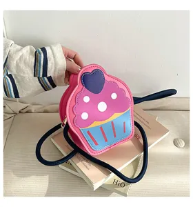 Detail shot of a cupcake-shaped crossbody bag with pink, purple and blue PU leather panels
