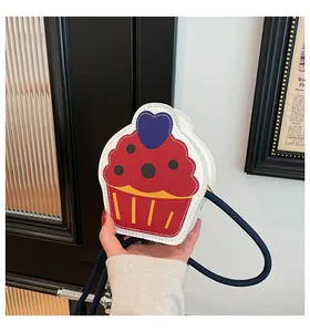 Detail of a cupcake-shaped crossbody bag featuring colorful leather and heart detail