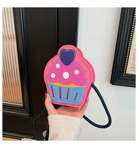 Detail of pink cupcake-shaped PU leather crossbody bag with heart and blue strap