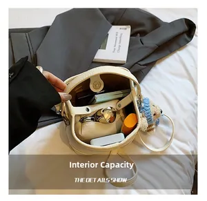 Beige pebble leather bucket bag interior showcasing ample capacity for daily essentials