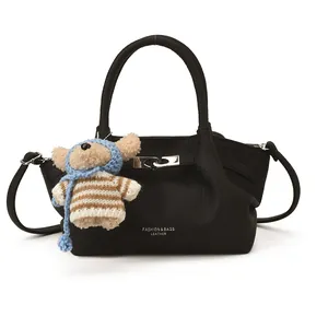 French style black litchi grain leather bucket bag with a cute plush bear pendant
