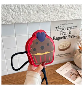 Close-up of creative red cupcake shaped shoulder bag with heart detail and shoulder strap