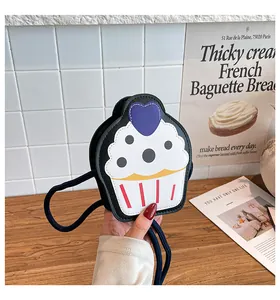 Detail of cupcake shaped crossbody bag with heart patch and dot patterns in high quality PU