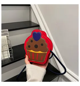 Detail of cupcake shaped crossbody bag with blue heart and colorful synthetic leather texture