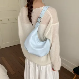 Light blue crescent shoulder bag in PU leather with silver metal buckle on the strap