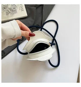 Close-up of white flower crossbody bag showing interior space and zipper details