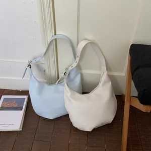 Sky blue and beige crescent hobo bags in soft leather with adjustable metal buckles