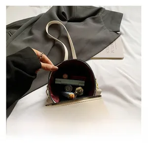Interior view of the cream bucket bag showing red lining and spacious cosmetic storage