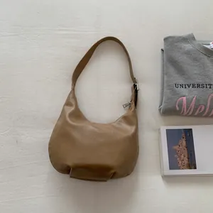 Detailed macro of the tan crescent hobo bag made of textured vegan leather