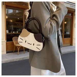 Lifestyle shot of cat shaped three color patchwork crossbody bag on a street