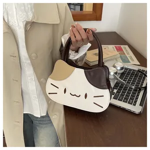Chic cat-shaped leather handbag with contrast patchwork and embroidery in urban scene