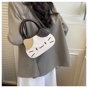 Close-up of cat-shaped handbag featuring contrast stitching and embroidery details