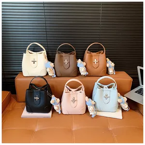 Collection of six faux leather bucket bags in assorted colors with plush bear charms