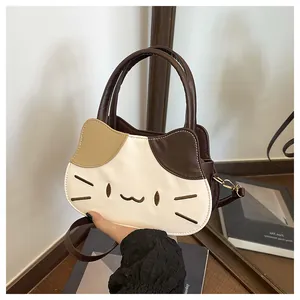 Detail of cute cat shaped handbag with contrast stitching and embroidery work