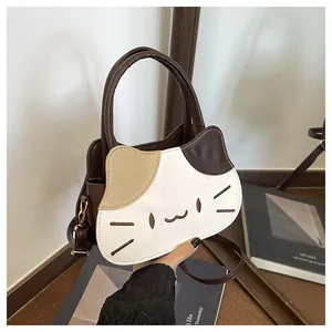 Detailed close-up of cute cat-shaped handbag featuring contrast stitching and embroidery