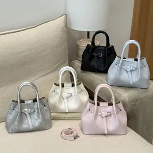 Multiple fashion bucket bags in diverse colors with adjustable shoulder strap detail