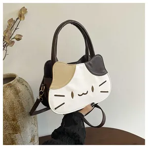 Detail view of the cat-shaped handbag featuring color-block design and embroidery