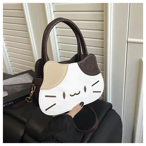 Detailed embroidery of cat whiskers and facial features on a color-blocked PU leather bag