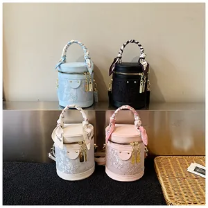 Floral embroidered bucket bags in four colors with silk scarf handles and gold padlocks